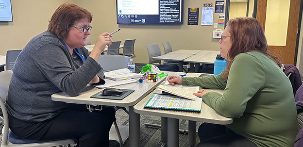 Staff member talking with student